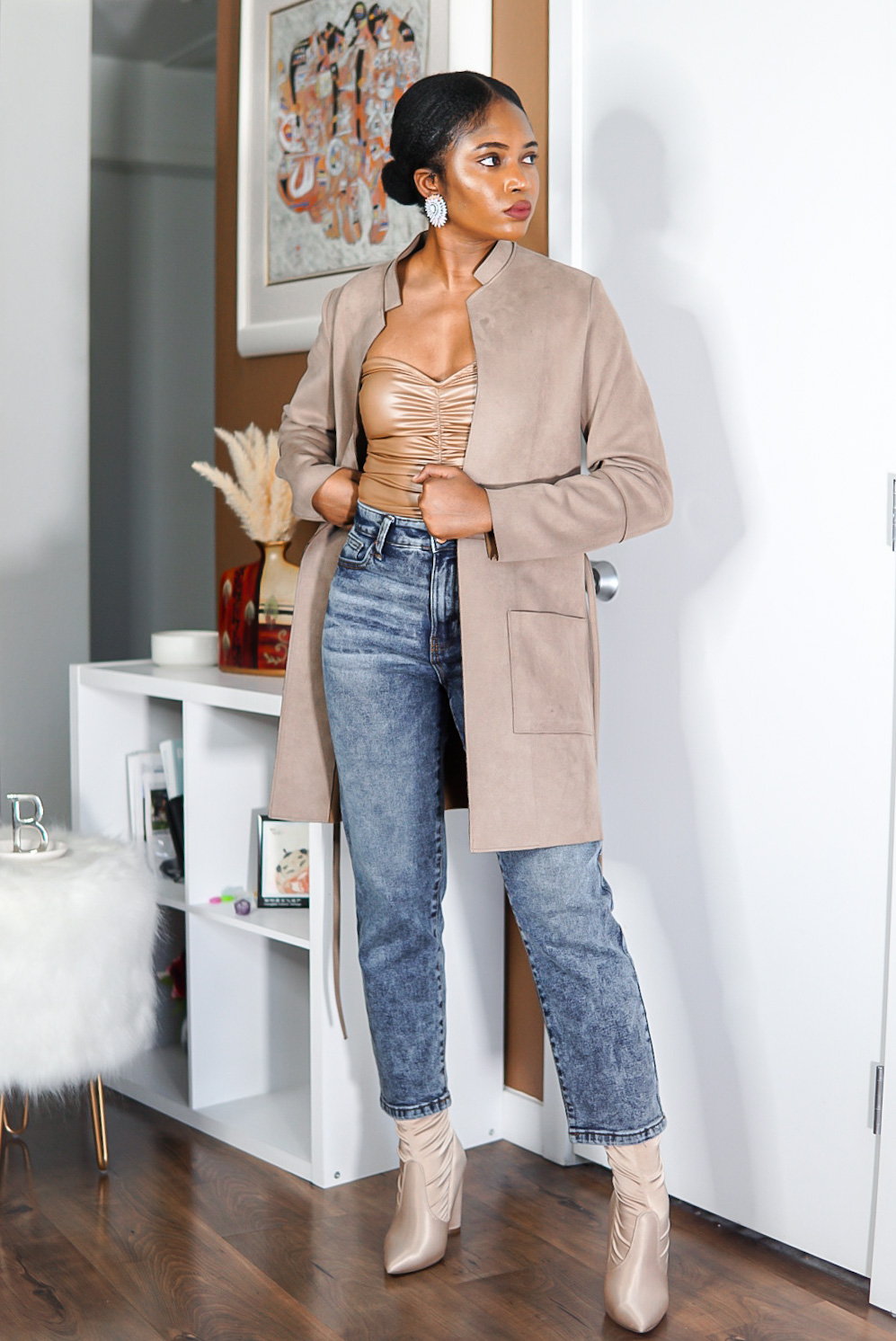 nude Fashionnova bodysuit paired with high-waisted denims