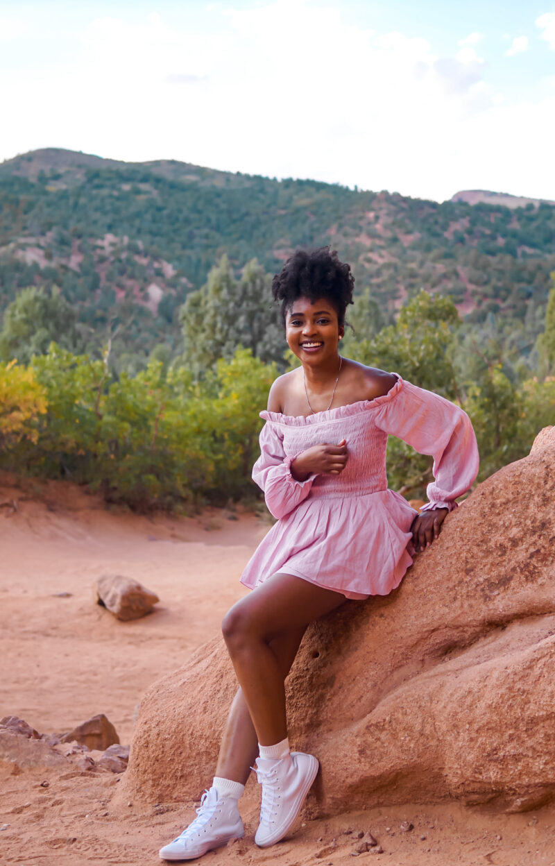 Woman outdoors at Garden of the Gods sharing tips on how to overcome a sheltered upbringing and gain independence