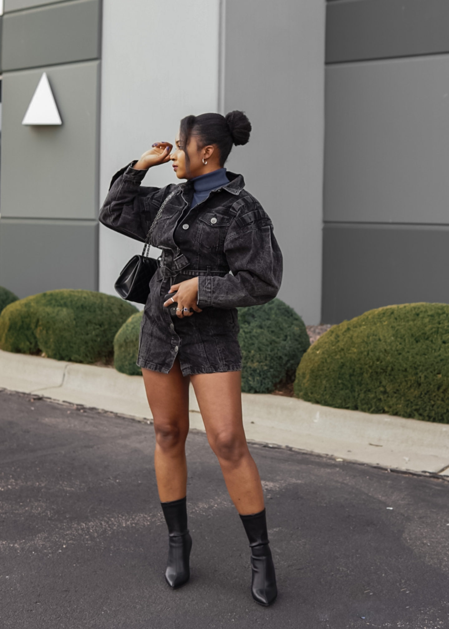 black woman posing in denim dress