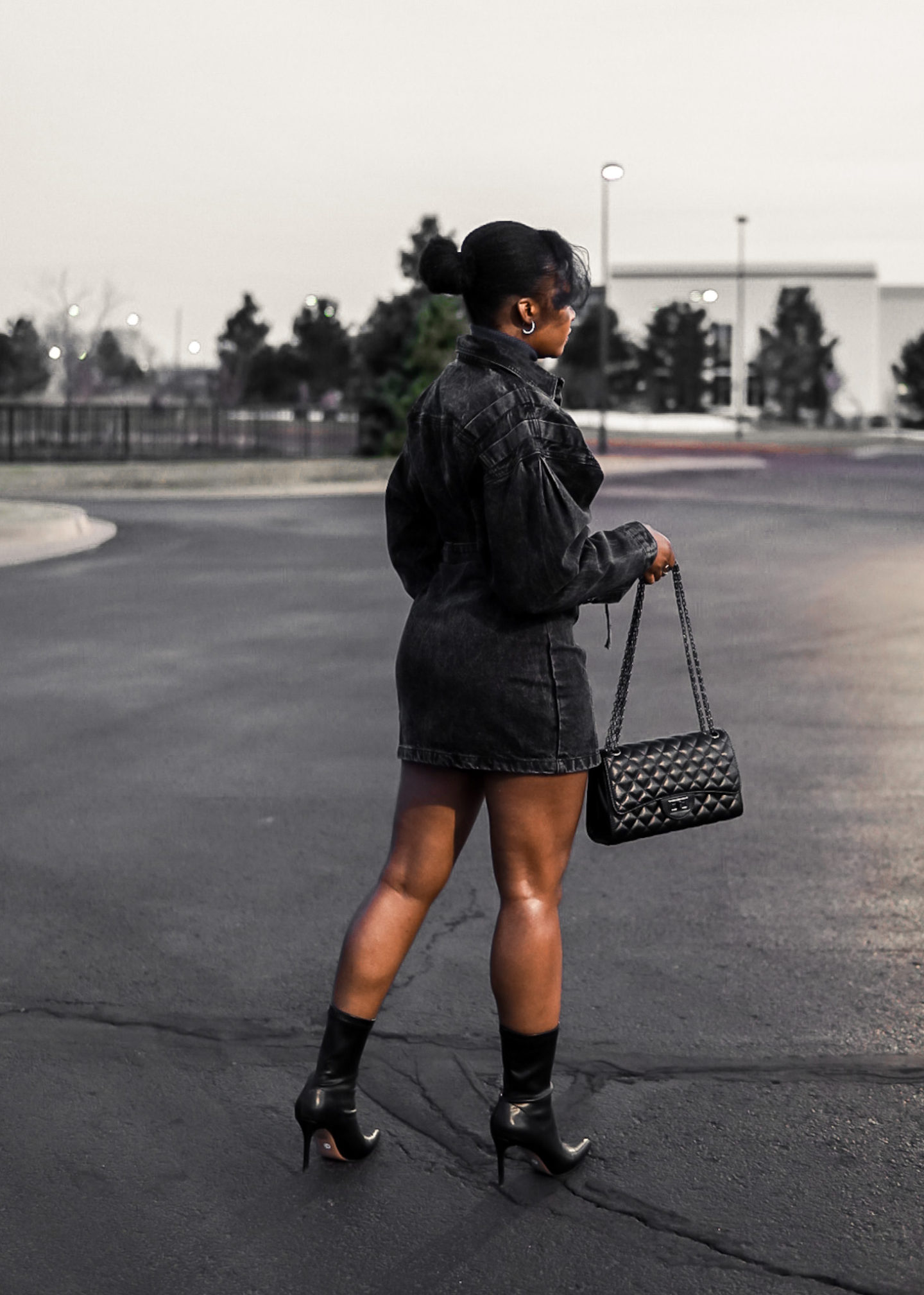 lady with bun black denim and booties