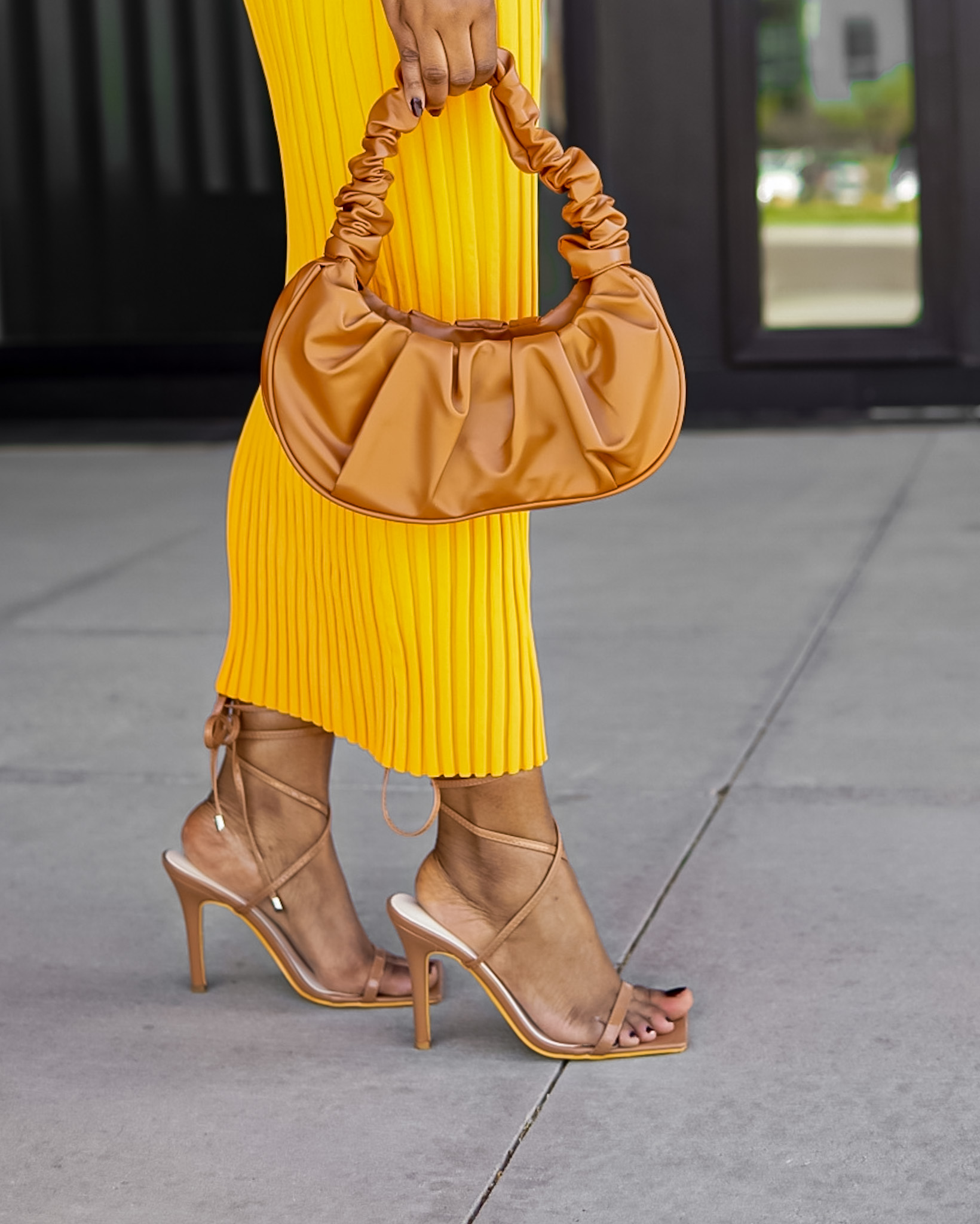 black woman midi skirt brown nude bag heels