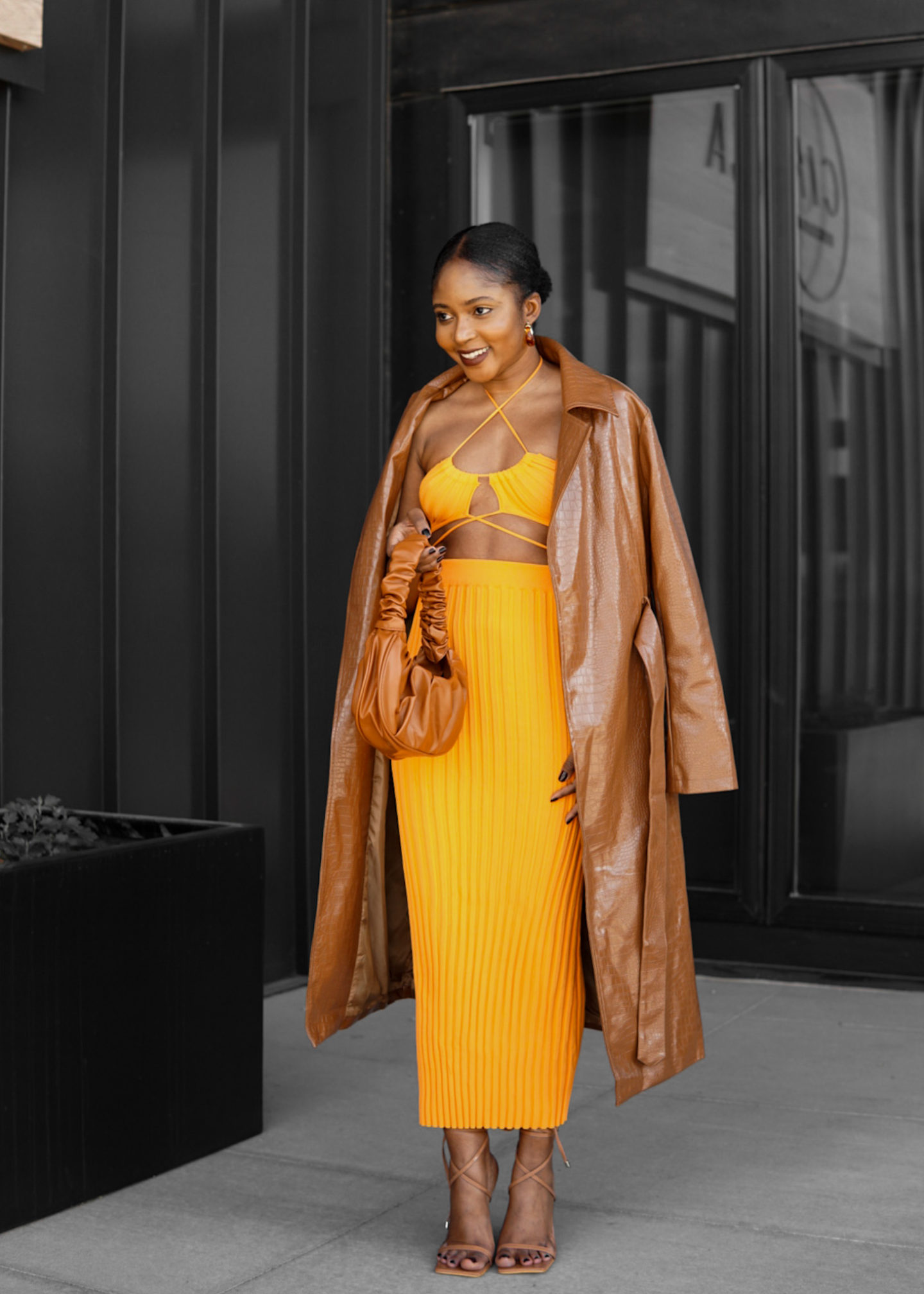 woman in orange two piece spring look trench coat