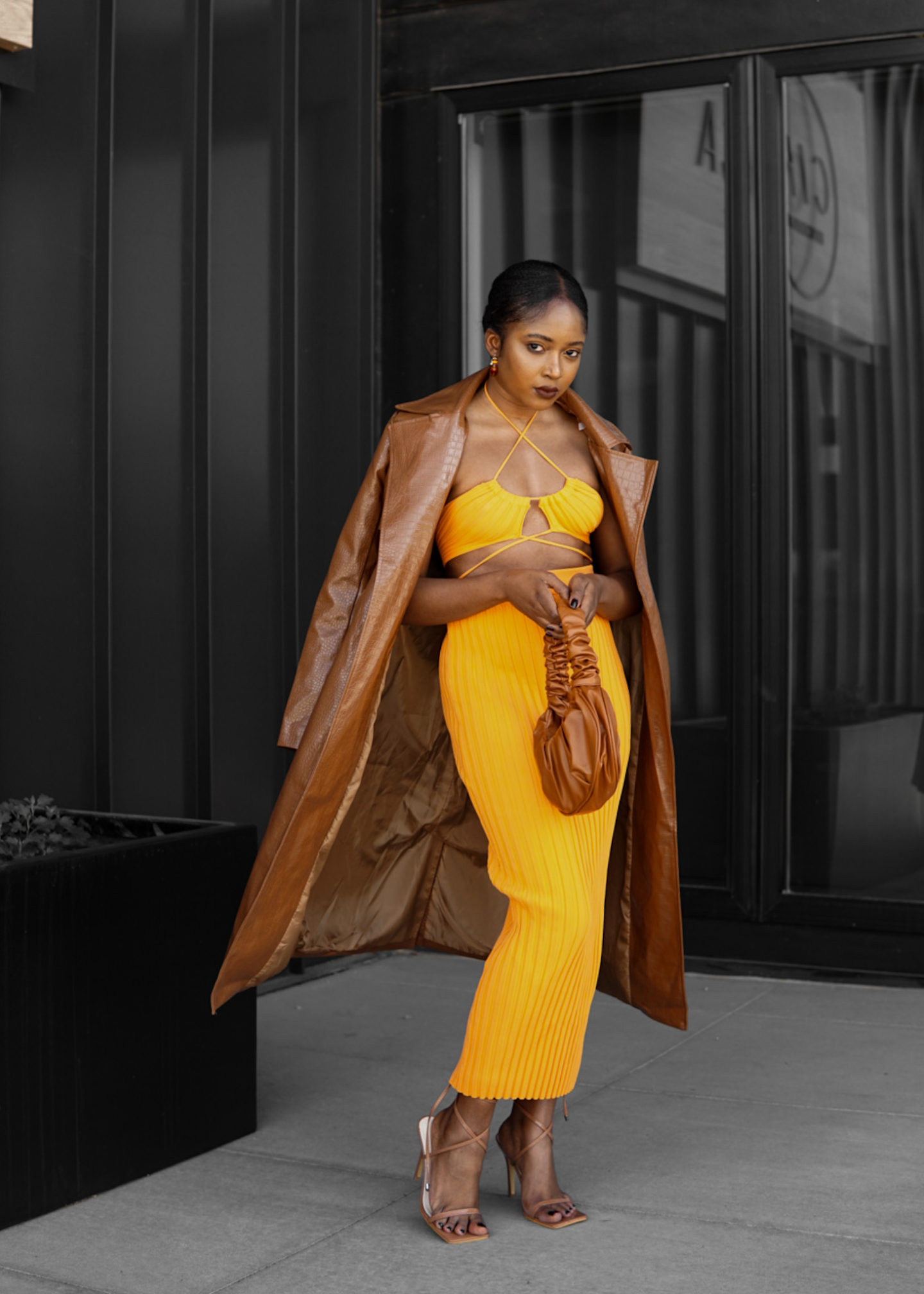 woman in orange two piece spring look trench coat