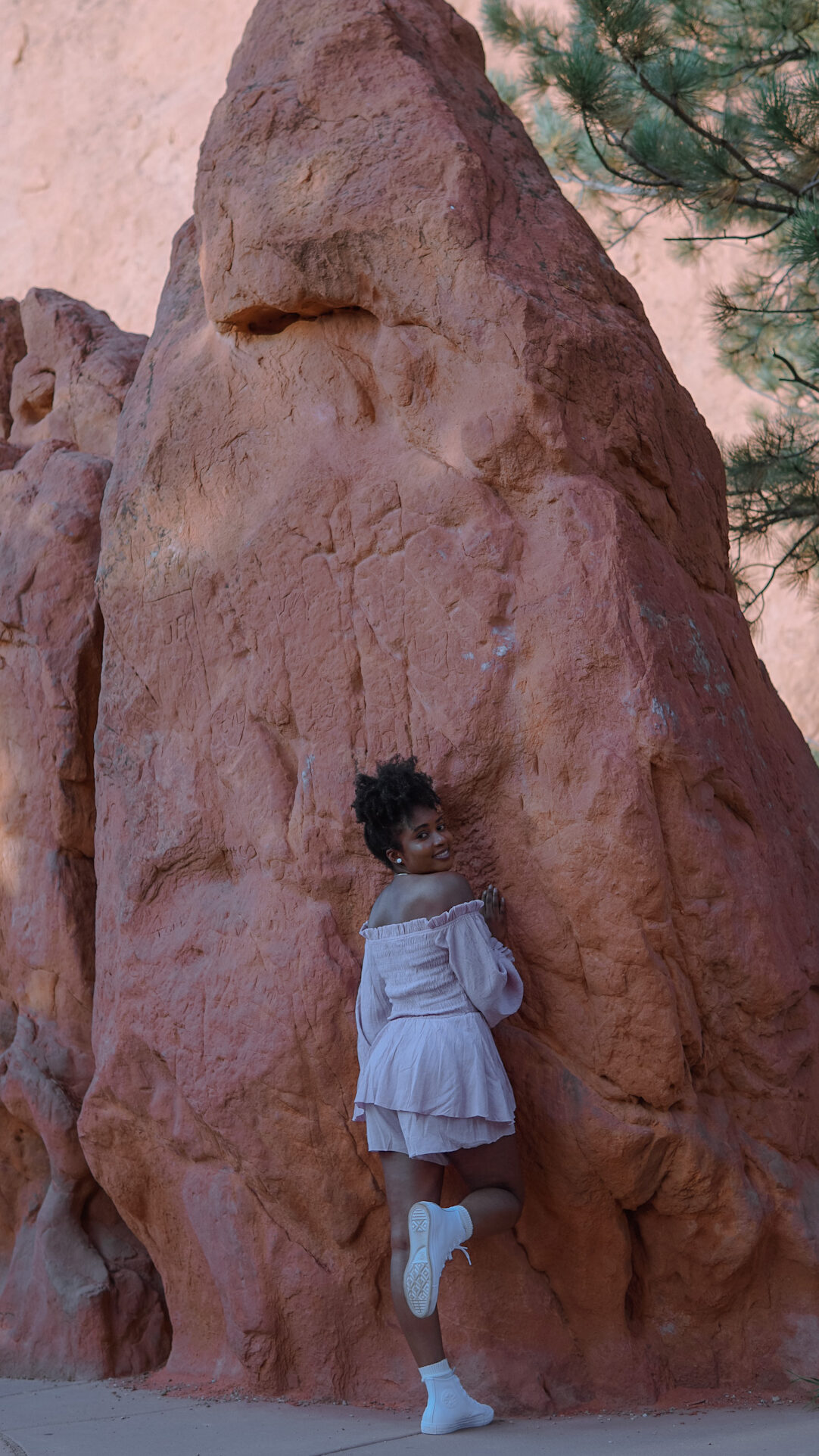 Young lady standing near red rock formations sharing tips on how to overcome a sheltered childhood